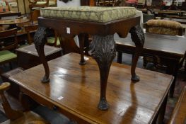 A Chippendale revival carved oak stool.