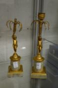 A pair of ormolu and marble cherub candlesticks (AF).