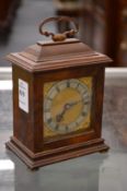 A miniature walnut bracket clock.