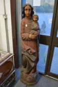 A large carved wood and polychrome decorated model of a Madonna and child.
