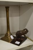 A small bronze elephant paperweight and a candlestick.