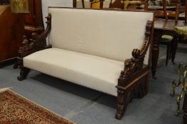 A good 19th century mahogany framed and cream upholstered settee with well carved figural end