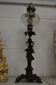 A small cast metal figural oil lamp.