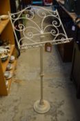 A painted wrought iron adjustable music stand.
