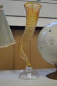 An unusual amber tinted glass horn shaped vase.