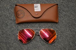 A cased pair of sunglasses.