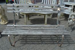 A wooden and wrought iron garden bench.