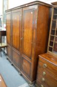 A walnut triple wardrobe.