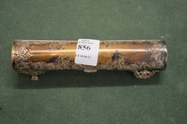 An engraved white metal cylindrical box and cover.