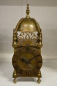 A small brass lantern clock.
