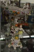 A continental porcelain centrepiece with figural support.