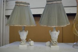 A pair of alabaster urn shaped table lamps.