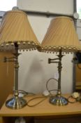 A pair of adjustable table lamps.
