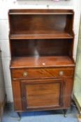 A small mahogany cupboard bookcase with open shelves above a single drawer and cupboard door.
