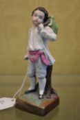 A small porcelain figure of a boy.