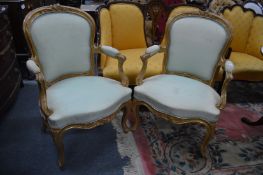 A pair of French style gilt framed open armchairs.