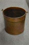 A copper coal bucket.