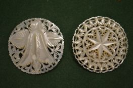 Two mother-of-pearl pierced and carved brooches.
