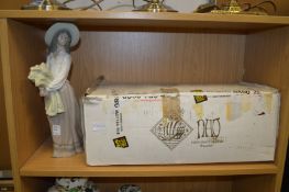 A large Nao porcelain figurine complete with original box.