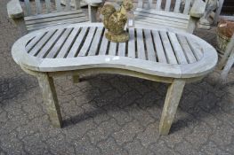 A weathered teak kidney shaped garden occasional table.