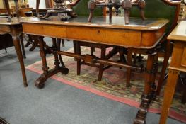 A Victorian oak two drawer library table on column supports.