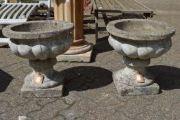 A pair of pedestal composite garden planters.