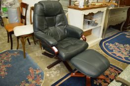 A modern green leather swivel recliner chair with matching footstool.