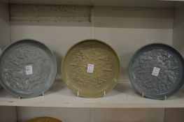 Three Chinese Celadon glazed circular dishes with moulded decoration.