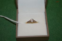 An 18ct gold, platinum and diamond solitaire ring.