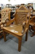 A good Victorian oak Gothic revival armchair with carved back.