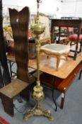 An ornate brass floor standing lamp.