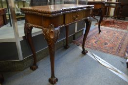 A good Chippendale revival carved mahogany foldover card table on carved cabriole legs with claw and