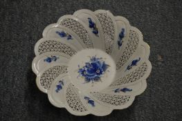 A small porcelain basket with pierced sides (cracked).