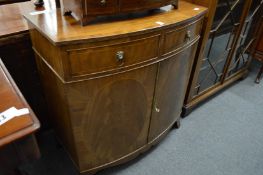 A mahogany bow front side cabinet with two drawers.