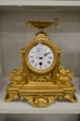 A gilt metal mantle clock.