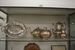 An oval dish and a four piece tea and coffee service.