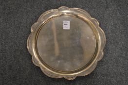 A silver salver with lobed rim.