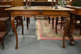A 19th century French walnut or fruitwood single drawer dining table.