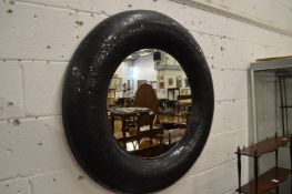 A stylish modern circular wall mirror with crackle glazed frame.