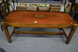 A brass bound mahogany coffee table.