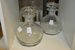 A pair of modern glass decanters.