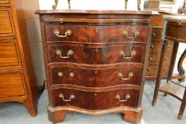 A George III style mahogany pedestal chest of serpentine outline with brushing slide over four
