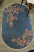 A small pale blue floral decorated Chinese rug.