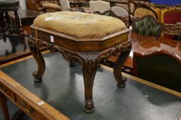 An octagonal shaped stool on carved cabriole legs.