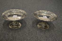 A pair of silver pedestal comports with pierced borders and foot rim.