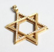 AN 18CT GOLD AND DIAMOND SET STAR OF DAVID PENDANT.