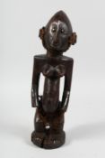 A GOOD CARVED WOOD AFRICAN FEMALE FIGURE. 18ins high.