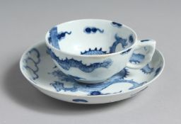 A BOW TEACUP AND SAUCER painted with the Dragon pattern, workman's mark