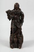 A 17TH CENTURY, POSSIBLY ITALIAN CARVED SAINT on an angel carved base. 15ins.