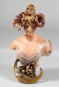 AN ART NOUVEAU POTTERY BUST. Head and shoulders of a young girl, flowers in her hair. Signed, Ed